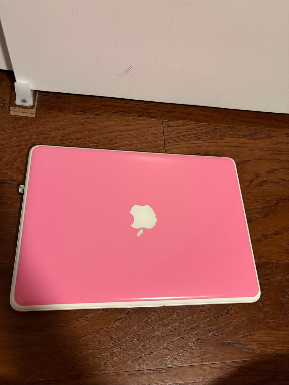 Apple Pink MacBook with Wired Headphones and a Pink Cover